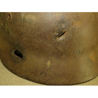 ET 64 marked M 35 war time reissued camouflaged steel helmet with fragmentation damage. Espenlaub militaria