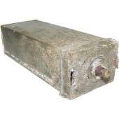 Deactivated 1 kilo explosive charge metal container.