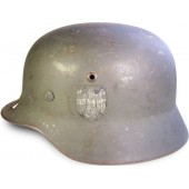 M 35 , Q 64 helmet, post 1940 year reissue, battle damaged !